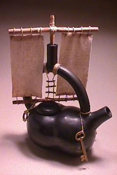 Poppykettle: coil built e blackened pit fire, terra sigillata and found objects.